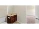 A full bathroom with neutral colored walls and a vanity with dark wood finish at 507 Vaughan Dr, Hampton, GA 30228