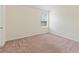 An empty bedroom with carpet and a window that provides natural lighting at 507 Vaughan Dr, Hampton, GA 30228