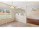 Dining area with tile floor, large window, and chandelier, adjacent to another room with hardwood flooring at 507 Vaughan Dr, Hampton, GA 30228