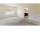 Bright dining room featuring neutral carpet, chandelier, wainscoting, and a large window offering plenty of natural light at 507 Vaughan Dr, Hampton, GA 30228