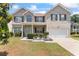Two-story brick home featuring a well-manicured front yard and covered front porch at 507 Vaughan Dr, Hampton, GA 30228
