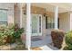 Inviting covered front porch with brick accents and decorative shrubs at 507 Vaughan Dr, Hampton, GA 30228