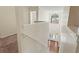 Bright hallway featuring wood and carpet flooring with natural light from the front door and window at 507 Vaughan Dr, Hampton, GA 30228