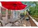 Enjoy outdoor dining on this back deck, complete with a table, chairs, and a red umbrella at 1274 Cotton Gin Dr, Powder Springs, GA 30127