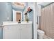 Blue bathroom with white cabinets, modern fixtures, and a shower with decorative curtain at 1274 Cotton Gin Dr, Powder Springs, GA 30127