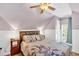 Cozy bedroom featuring slanted ceiling, bed, nightstand and ample natural light at 1274 Cotton Gin Dr, Powder Springs, GA 30127