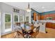 Sunlit breakfast nook with a wooden table, three windows, and a clear view of the wood deck at 1274 Cotton Gin Dr, Powder Springs, GA 30127