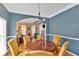 Cozy dining room featuring a classic chandelier, warm-toned walls, and hardwood floors at 1274 Cotton Gin Dr, Powder Springs, GA 30127