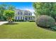 Charming two-story home featuring lush landscaping, a sprawling green lawn, and a welcoming front porch at 1274 Cotton Gin Dr, Powder Springs, GA 30127
