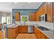 Well-equipped kitchen featuring wooden cabinetry, stainless steel appliances, and ample counter space for cooking at 1274 Cotton Gin Dr, Powder Springs, GA 30127