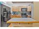 This kitchen boasts wooden cabinets, black appliances, and an island with a butcher block countertop at 1274 Cotton Gin Dr, Powder Springs, GA 30127