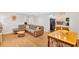 Open-concept living room with hardwood floors, comfortable sofa, and view of the kitchen area at 1274 Cotton Gin Dr, Powder Springs, GA 30127