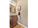 Elegant powder room with dark wood vanity, marble countertop, and decorative mirror adding to the vintage style at 1274 Cotton Gin Dr, Powder Springs, GA 30127