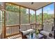 Relaxing screened porch with comfortable seating and views of the surrounding greenery at 1274 Cotton Gin Dr, Powder Springs, GA 30127