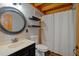 Cozy bathroom with round mirror, open shelves, toilet, and a shower with curtain at 179 Hogan Rd, Brooks, GA 30205
