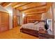 Comfortable bedroom with wood floors, wood paneled ceiling, and traditional furnishings at 179 Hogan Rd, Brooks, GA 30205
