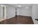 Empty bedroom with a neutral color scheme, modern ceiling fan, and dark wood floors at 179 Hogan Rd, Brooks, GA 30205