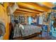Rustic bedroom featuring a wood-paneled ceiling and walls, filled with hunting decorations and mounted animals at 179 Hogan Rd, Brooks, GA 30205
