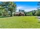 Spacious front yard with mature trees and a charming exterior showcasing natural beauty at 179 Hogan Rd, Brooks, GA 30205