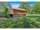 Beautiful log home featuring a full porch and backyard at 179 Hogan Rd, Brooks, GA 30205
