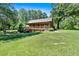 A charming log cabin nestled in a serene, wooded landscape at 179 Hogan Rd, Brooks, GA 30205