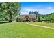 Inviting home featuring a lush front lawn and a charming stone pathway leading to the covered front porch at 179 Hogan Rd, Brooks, GA 30205