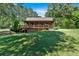 Charming log home with inviting porch and lush, green lawn at 179 Hogan Rd, Brooks, GA 30205