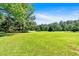 Expansive front lawn and mature trees create a picturesque setting for this beautiful homesite at 179 Hogan Rd, Brooks, GA 30205