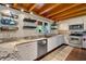 Updated kitchen with granite countertops, stainless steel appliances, and wooden ceiling at 179 Hogan Rd, Brooks, GA 30205