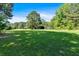 Spacious lot with lush green grass and mature trees, offering endless possibilities at 179 Hogan Rd, Brooks, GA 30205