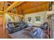 Spacious living room with a stone fireplace, wood floors, and plenty of seating at 179 Hogan Rd, Brooks, GA 30205
