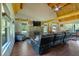 Cozy living room featuring a stone fireplace, wood floors, and a vaulted ceiling with exposed beams at 179 Hogan Rd, Brooks, GA 30205