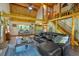 Open-concept living room with a stone fireplace, dining area, and exposed beams, perfect for entertaining at 179 Hogan Rd, Brooks, GA 30205
