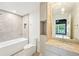 This bathroom features a tub, a vanity, and views to the bedroom with hardwood floors at 1815 Coventry Rd, Decatur, GA 30030