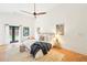 Bright primary bedroom with wood floors, ceiling fan, and French doors at 1815 Coventry Rd, Decatur, GA 30030