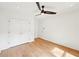 A minimalist bedroom with a modern ceiling fan and hardwood floors at 1815 Coventry Rd, Decatur, GA 30030