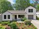 Attractive home exterior showcasing white brick, a gray roof, and beautifully landscaped front yard at 1815 Coventry Rd, Decatur, GA 30030