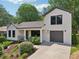 Charming exterior of a modern home with white brick, contrasting trim, and well-manicured landscaping at 1815 Coventry Rd, Decatur, GA 30030