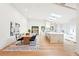 Modern kitchen and dining area with skylights, white cabinets, a large island, and wood floors at 1815 Coventry Rd, Decatur, GA 30030