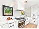 Modern kitchen with stainless steel appliances, marble counters, and bright natural light at 1815 Coventry Rd, Decatur, GA 30030