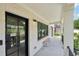Inviting porch with tiled floor, stylish lighting, and a cozy wooden bench at 1815 Coventry Rd, Decatur, GA 30030