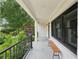 Inviting covered porch with stone flooring and wood bench seating, perfect for relaxing outdoors at 1815 Coventry Rd, Decatur, GA 30030