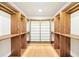 Spacious walk-in closet with wood built-ins, shelving, and glass shelves at 1815 Coventry Rd, Decatur, GA 30030
