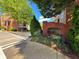 Entrance to the Enclave at Milton Park community with a brick sign and lush landscaping at 2728 Wander Ln, Alpharetta, GA 30022
