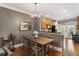 This dining room has a chandelier, a wooden table with chairs, and flows into the kitchen with stainless steel appliances at 2728 Wander Ln, Alpharetta, GA 30022
