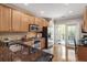 Well-lit kitchen with stainless steel appliances, granite countertops, and wood cabinets at 2728 Wander Ln, Alpharetta, GA 30022