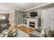Cozy living room with a fireplace, hardwood floors, and comfortable seating arrangement at 2728 Wander Ln, Alpharetta, GA 30022