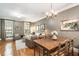 Spacious living room with hardwood floors, a cozy seating area, and abundant natural light from large windows at 2728 Wander Ln, Alpharetta, GA 30022