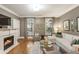 Inviting living room with fireplace, hardwood floors, and white sectional sofa at 2728 Wander Ln, Alpharetta, GA 30022