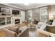 Inviting living room featuring a fireplace, hardwood floors, and neutral-toned furniture at 2728 Wander Ln, Alpharetta, GA 30022